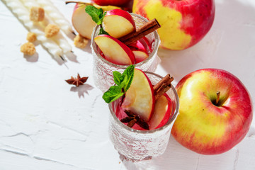 mulled wine in fishnet glasses on a light background, Apple, cinnamon, wine