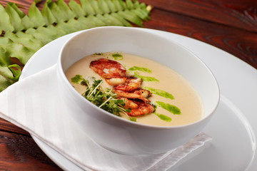 Creamy cheese soup with grilled shrimps