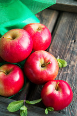 group of red apples on wooden natural background, fresh natural food and vitamins concept in rustic style