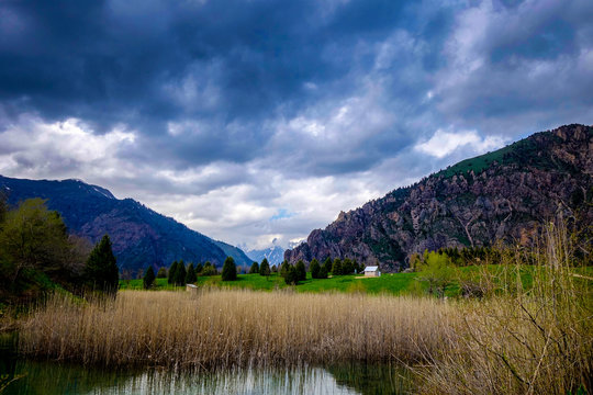 Marshes around a lake with dramatic cloudy skies in the UNESCO world heritage site of Sary-Chelek Biosphere Reserve   in the Jalal-Abad province of Western Kyrgyzstan