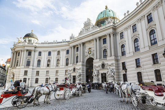Horse drawn carriages in front of the Hofburg Palace, Vienna, Austria.