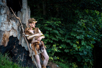 Young couple of elves in love standing in magical forest outdoor on nature. Fairy tale of love, relationship and magik people concept. Man ambracing woman