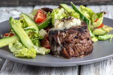 Grilled steak meat with potato gratin and vegetables