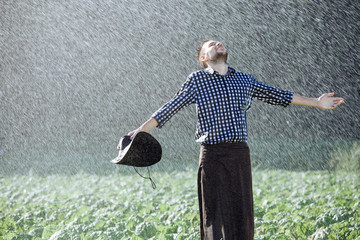 man wet under rain farmer hat enjoy prayer happy upset heavy wet water shower sun summer pray