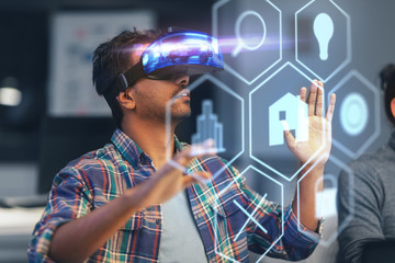 deadline, augmented reality and technology concept - creative man with virtual headset or vr glasses and hologram of menu icons at night office
