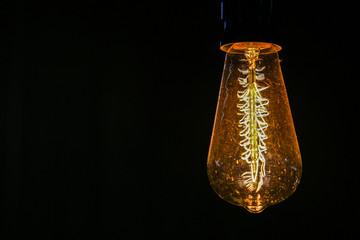 Yellow white bulb in absolute darkness