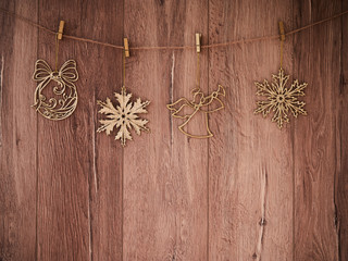 Christmas decorations on a wooden background. New Year decorations and free space for text on a wooden background. Holidays decor on the clothespins. Vintage texture