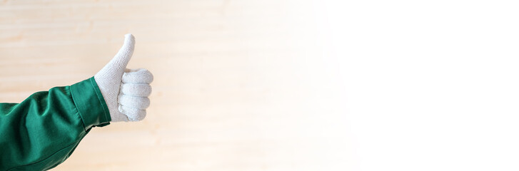 Hand in white fabric gloves thumbs up