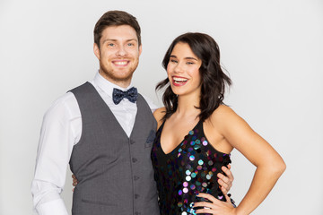 fashion, style and holidays concept - happy couple hugging at party