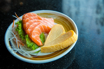 Fresh salmon slice and japanese omelette heart shape side dish by lettuce and radish. Clean  and fresh food for healthy concept.