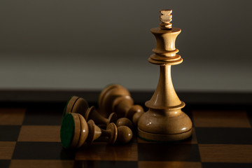 King Chess Piece lying on the side of Kingpiece in the chessboard