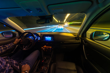 Movement of the car at night at a speed view from the interior, Brilliant road with lights with a car at high speed