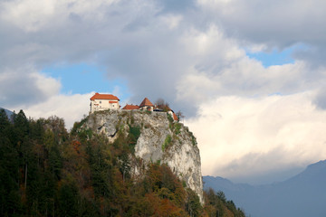 Fototapeta na wymiar Medieval Bled Castle on the cliff above Lake Bled. Lake Bled is a popular travel destination in Slovenia. 