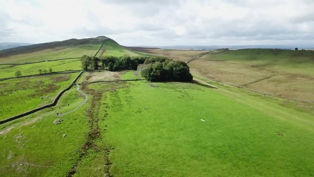 Aerial England Scotland Hadrians Wall medieval history 4K. Hadrian's Wall was a defensive fortification in the Roman province of Britannia built in AD122. Britain's ancient tourist attraction.