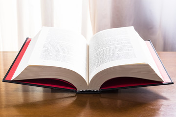 Hard cover books organized over wooden table