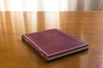 Hard cover books organized over wooden table