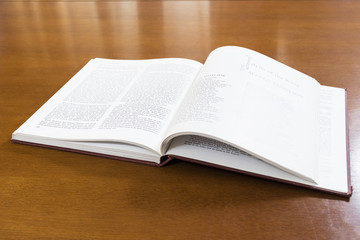 Obraz premium Hard cover books organized over wooden table