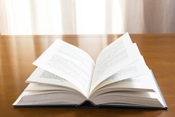 Fototapeta premium Hard cover books organized over wooden table