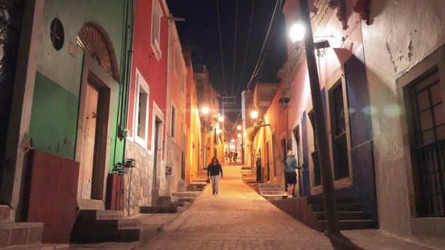 People walking on colorful street of the colonial city of Guanajuato, Mexico.
