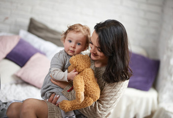 mom and daughter with a soft toy, mother's day, March 8, love and mom warm