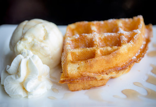waffle and vanilla ice cream two scoops and maple syrup. popular sweets and dessert. sweet, fat and high calories. image for background, wallpaper, copy space and menu list.