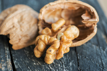 Walnuts kernels on dark desk with color background, Whole walnut  with worm. bad-quality product 