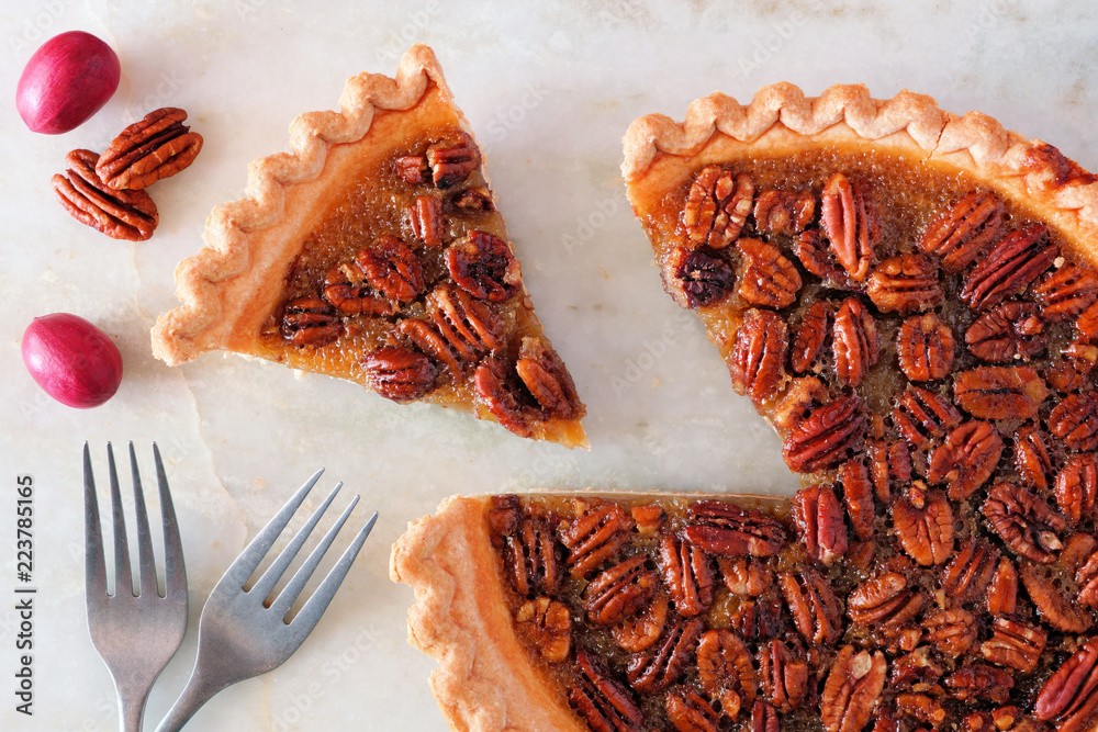 Poster autumn pecan pie, top view with cut slice on a bright background