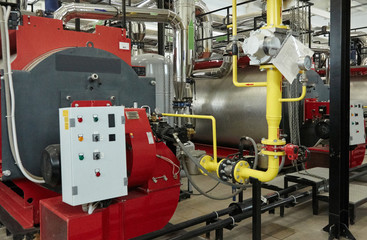 Modern new gas heating coppers work in a boiler room.