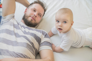 father and baby son together on light background
