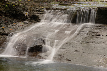 Fototapeta premium Waterfall on small creek in late summer