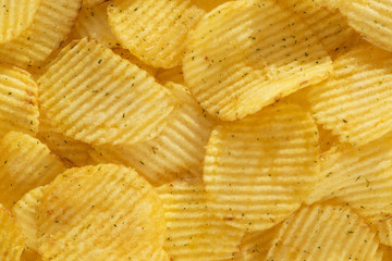 Handful of yellow potato chips