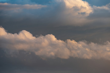Fototapeta na wymiar Beautiful cumulonimbus stormy rain cloud formations in Summer sunset sky with dramatic moody color and texture