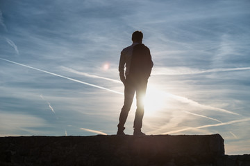Man silhouetted against the setting sun