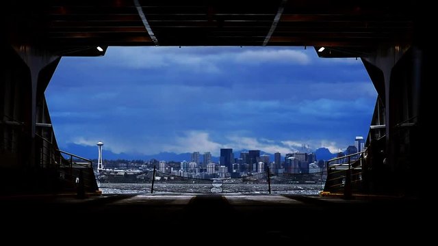 Seattle skyline framed by Ferry turning during a storm