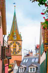 Beautiful cozy street and tower of Saint Peter church in the city center of Zurich, Switzerland