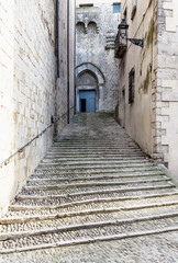 Fototapeta na wymiar Steep stairs and narrow street in old town of Gerona, Spain