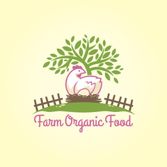 Chicken with egg in the nest under the tree