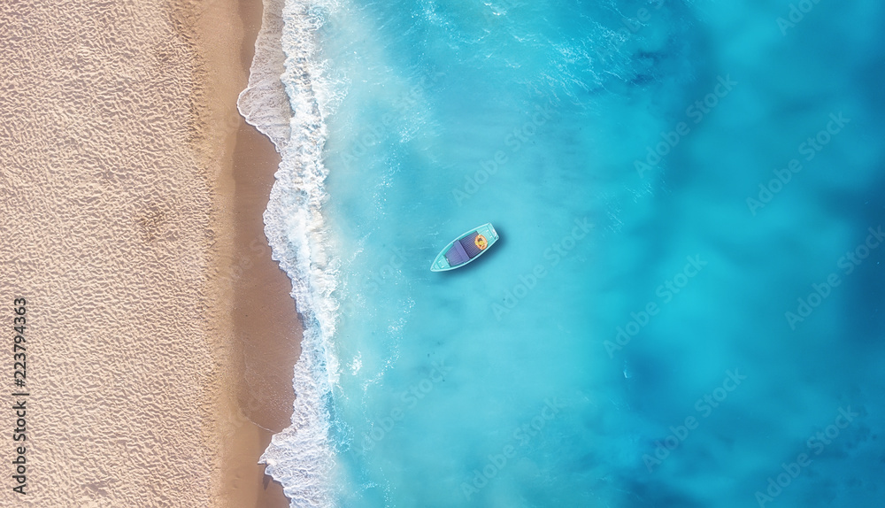 Wall mural boat on the water surface from top view. turquoise water background from top view. summer seascape f