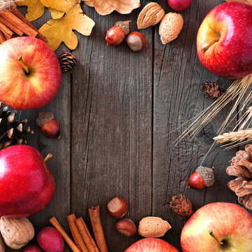 Autumn square frame of apples and fall ingredients on a rustic wood background with copy space