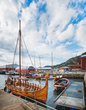 Old Town pier with old boats and sailing ship. Historical district of the Bryggen - Hanseatic wharf in Bergen, Norway.
