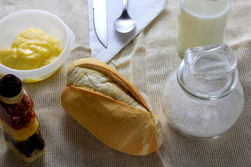 close up french bread on breakfast table with butter and cutlery