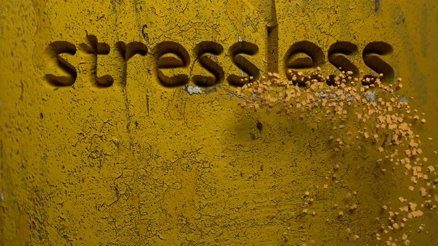 animation of stressless life word carved in a yellow wall