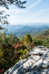 smoky mountains in autumn with blue sky and fog