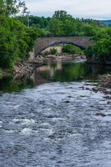 Fototapeta na wymiar A view of a bridge crossing over the Ausable River