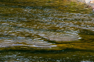 Ripples in the water as they flow over the rocks