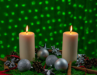 Obraz na płótnie Canvas A Christmas arrangement with two burning candles