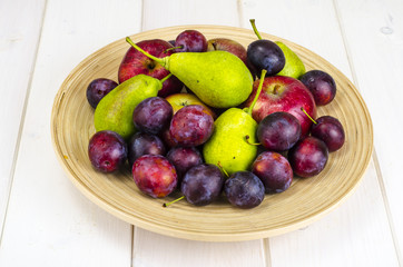 Ripe fruit on wooden plate