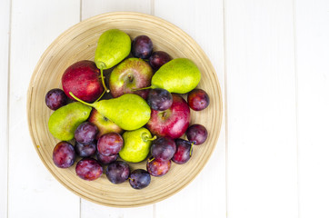 Ripe fruit on wooden plate