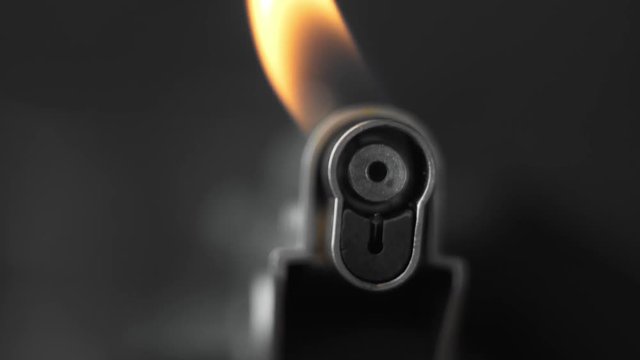 Chef uses a lighter. Gas Lighter with Flame. Fire.
