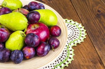 Ripe fruit on wooden plate